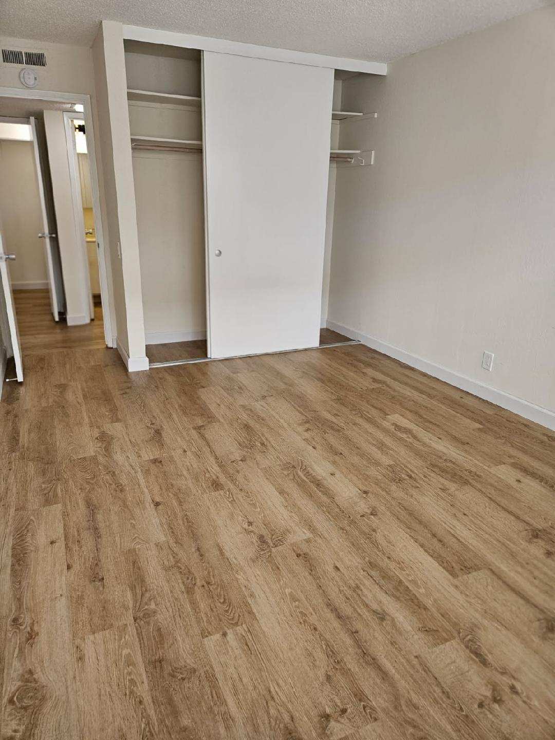 Finished LVP flooring in an Oakland rental bedroom after installation